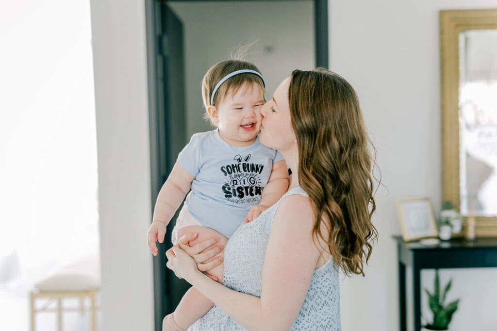 Richmond baby milestone photographer session showing a chubby one-year-old and her big sister announcement.