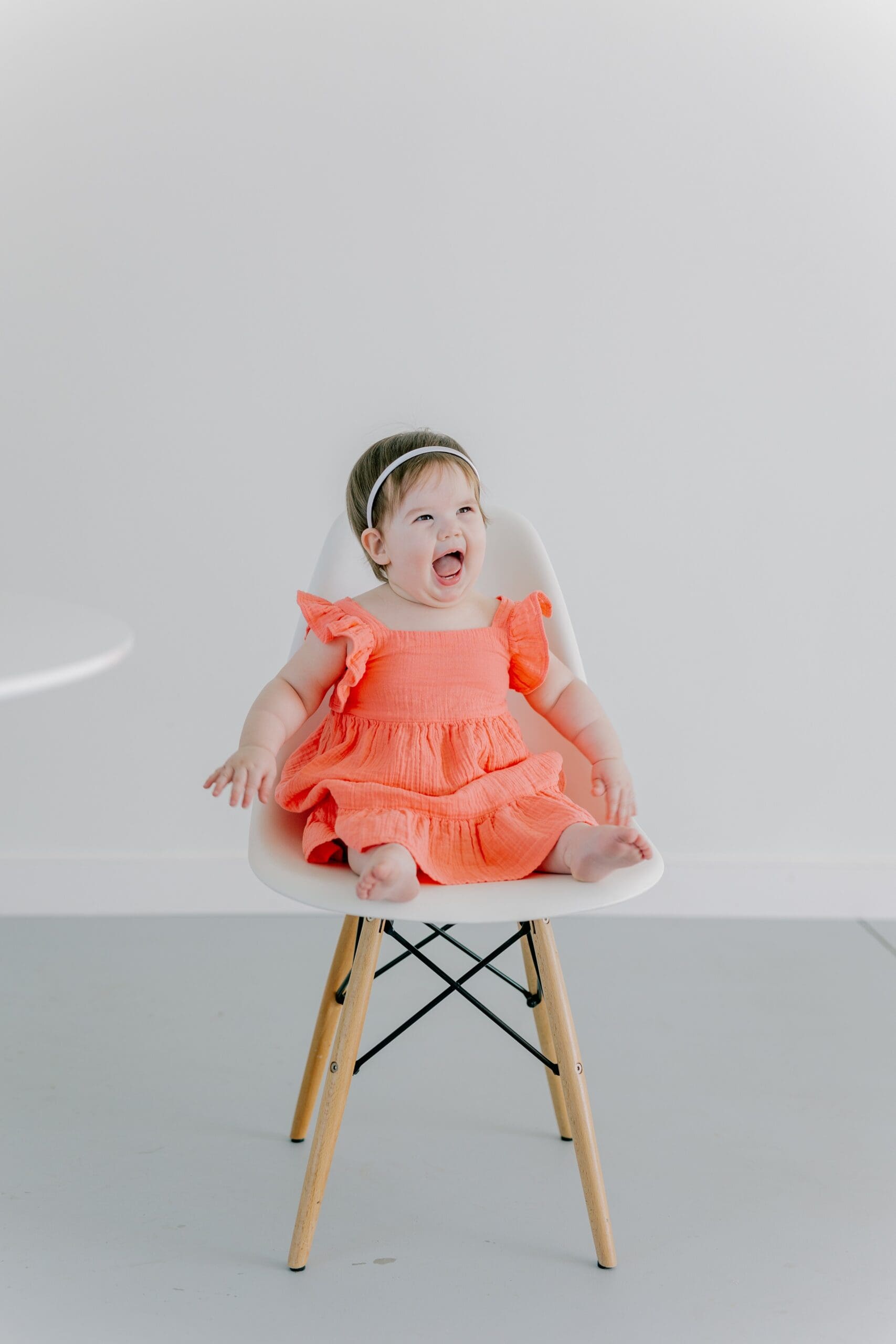 A baby poses during her first birthday photo session.