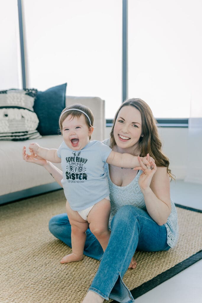 Richmond baby milestone photographer session showing a chubby one-year-old and her big sister announcement.