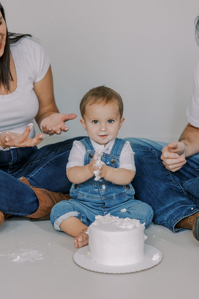 Cake smash photography in Richmond session featuring baby Lincoln enjoying his first birthday cake at our studio.