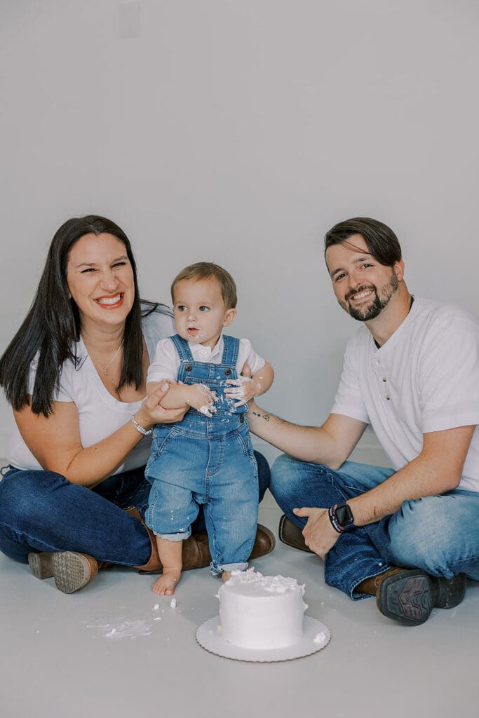 Cake smash photography in Richmond session featuring baby Lincoln enjoying his first birthday cake at our studio.