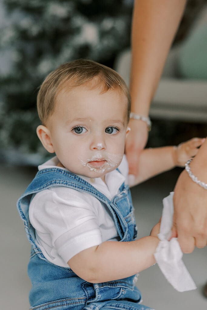 Cake smash photography in Richmond session featuring baby Lincoln enjoying his first birthday cake at our studio.