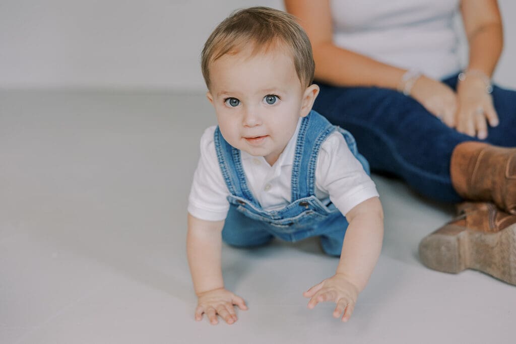 Cake smash photography in Richmond session featuring baby Lincoln enjoying his first birthday cake at our studio.