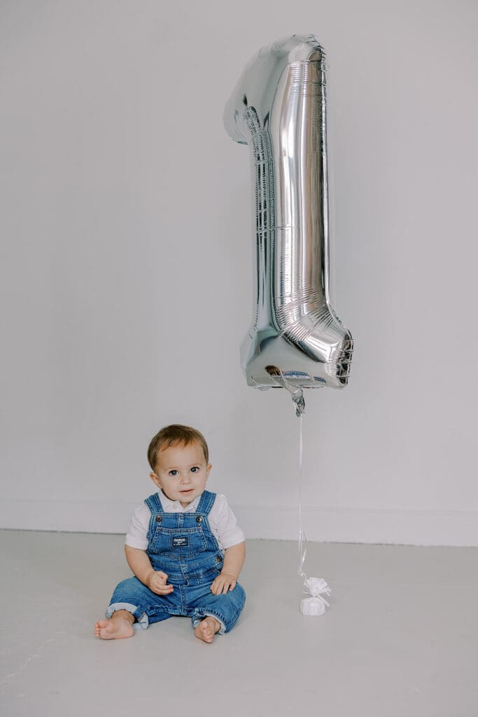 Cake smash photography in Richmond session featuring baby Lincoln enjoying his first birthday cake at our studio.