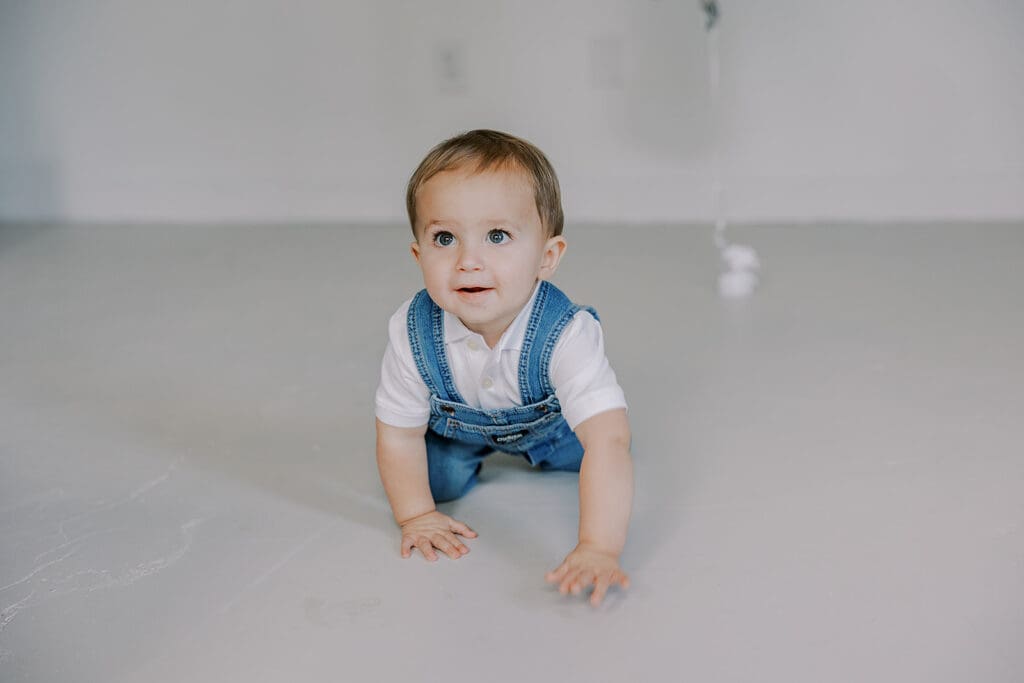 Cake smash photography in Richmond session featuring baby Lincoln enjoying his first birthday cake at our studio.