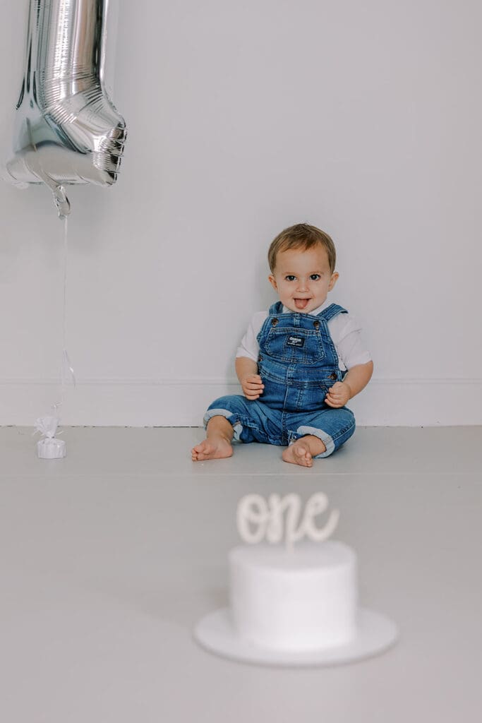 Cake smash photography in Richmond session featuring baby Lincoln enjoying his first birthday cake at our studio.