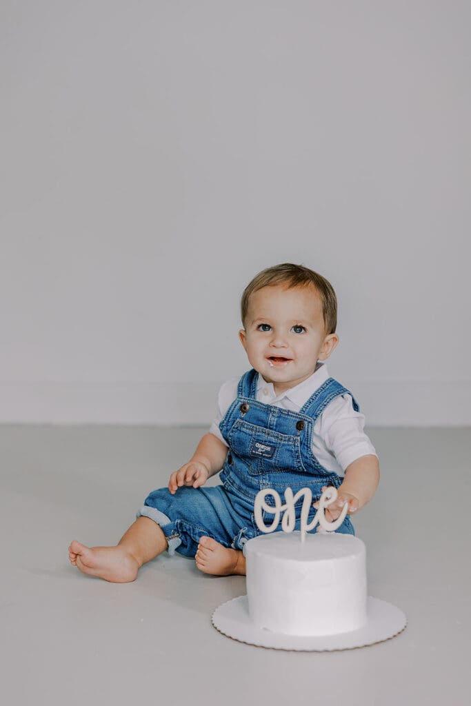 Cake smash photography in Richmond session featuring baby Lincoln enjoying his first birthday cake at our studio.