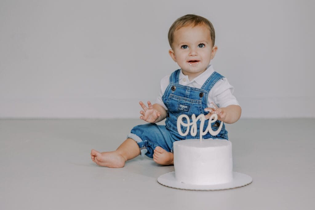 Baby boy during his cake smash milestone session for one year.