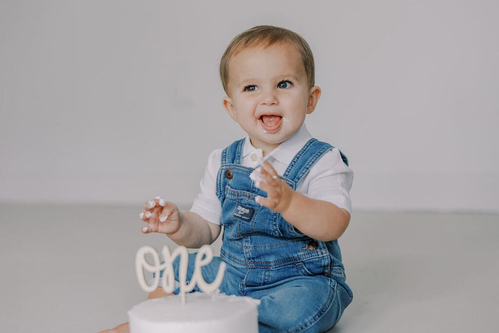 Cake smash photography in Richmond session featuring baby Lincoln enjoying his first birthday cake at our studio.