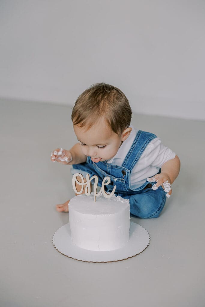 Cake smash photography in Richmond session featuring baby Lincoln enjoying his first birthday cake at our studio.