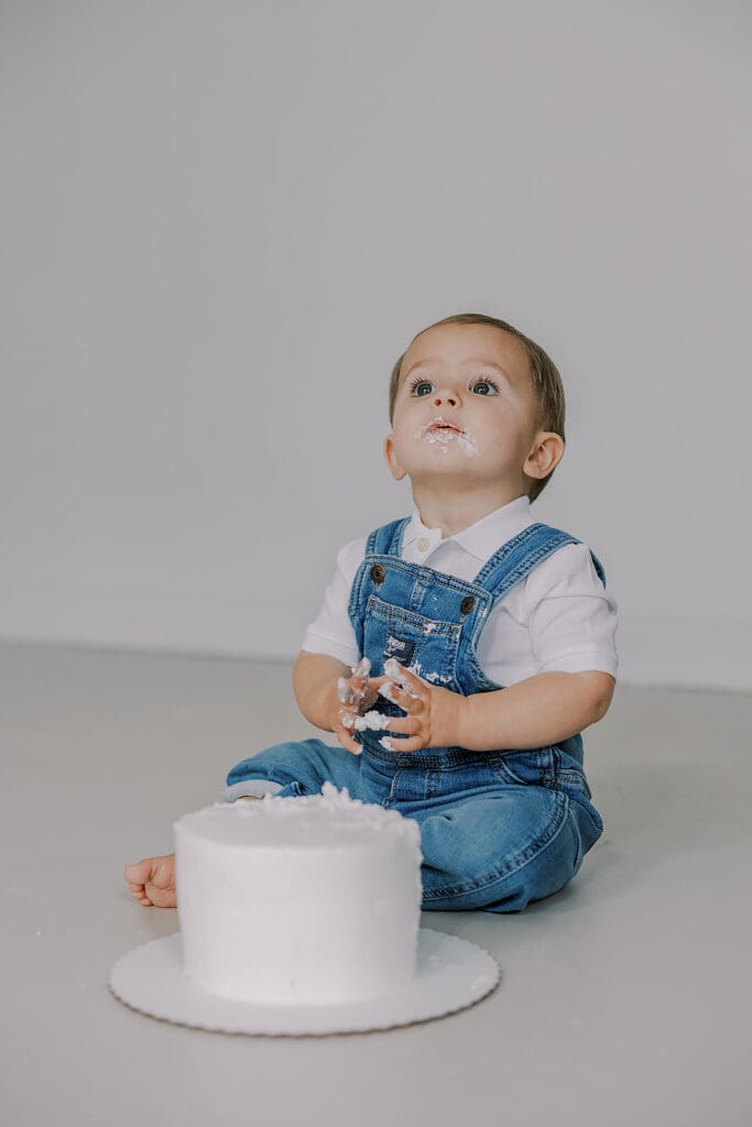 Cake smash photography in Richmond session featuring baby Lincoln enjoying his first birthday cake at our studio.