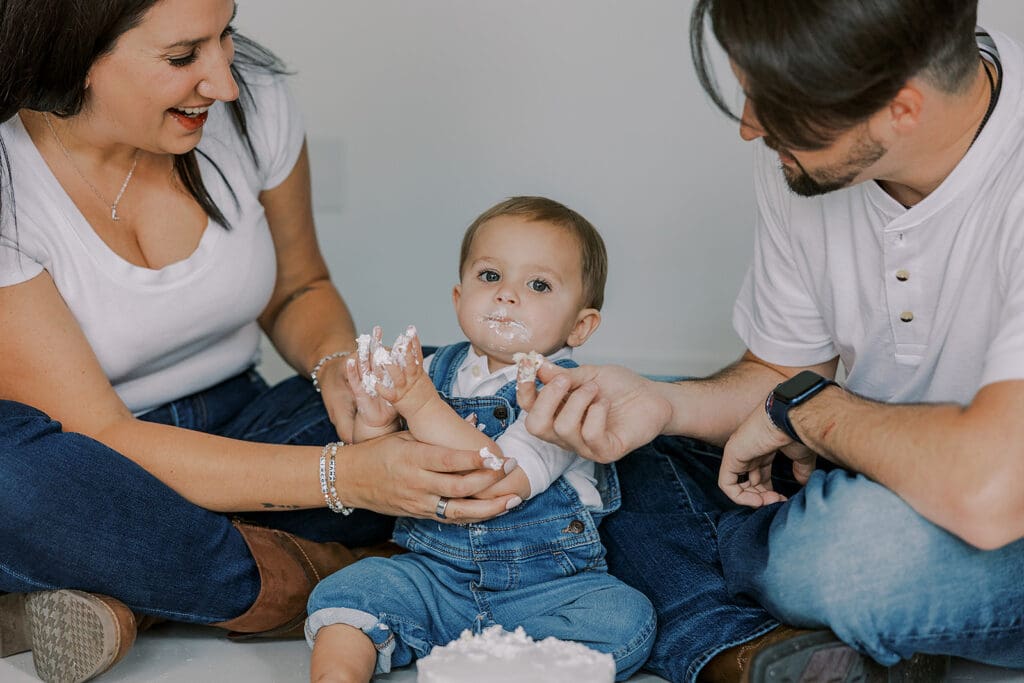 Cake smash photography in Richmond session featuring baby Lincoln enjoying his first birthday cake at our studio.