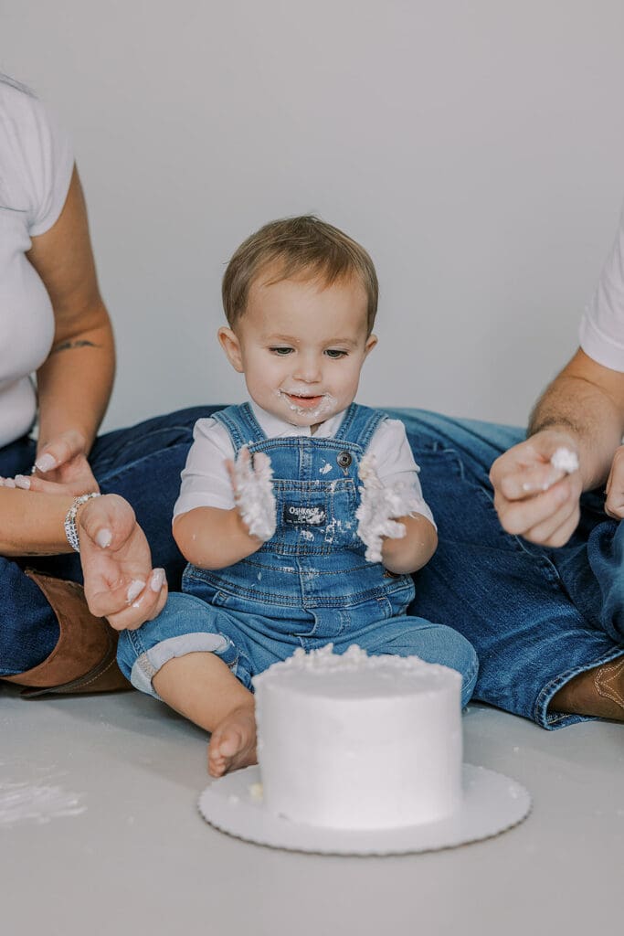 Cake smash photography in Richmond session featuring baby Lincoln enjoying his first birthday cake at our studio.