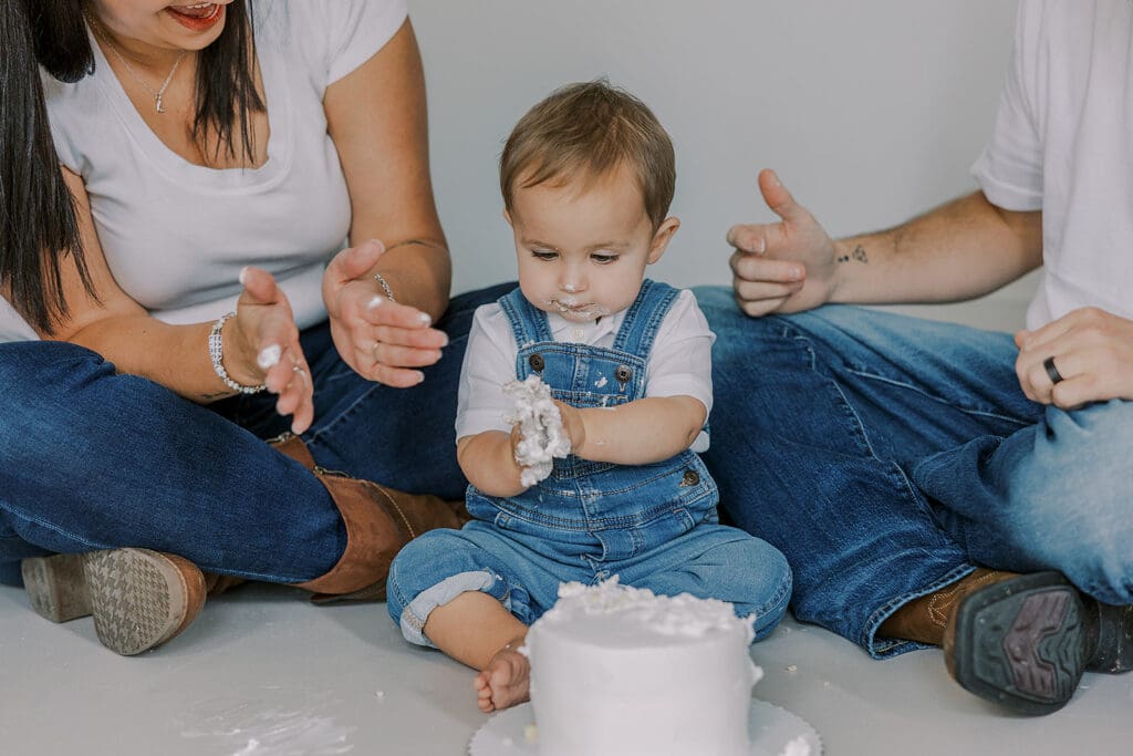 Cake smash photography in Richmond session featuring baby Lincoln enjoying his first birthday cake at our studio.