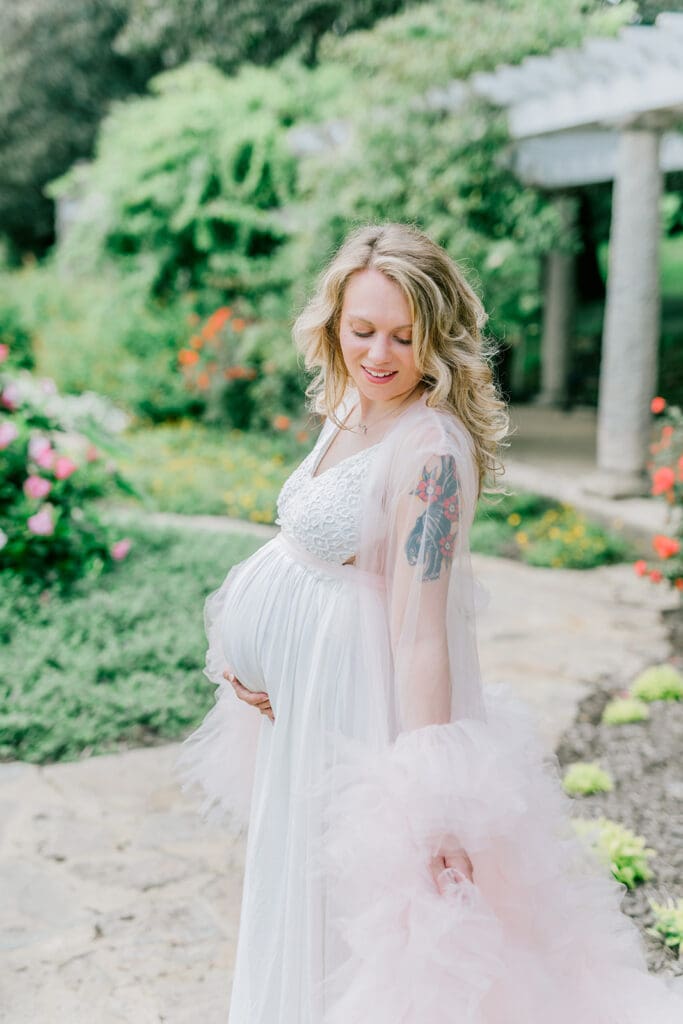 Maymont spring maternity photography featuring Cameron in a flowing pink gown surrounded by blooming gardens.