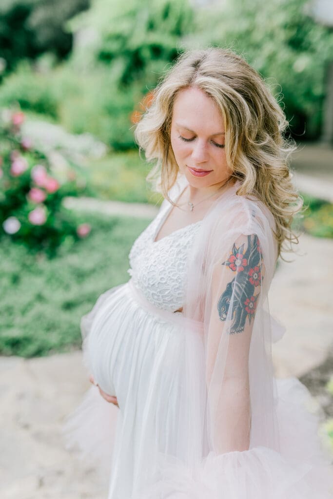 Maymont spring maternity photography featuring Cameron in a flowing pink gown surrounded by blooming gardens.