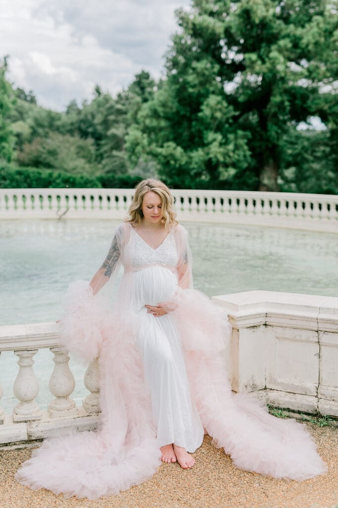 Maymont spring maternity photography featuring Cameron in a flowing pink gown surrounded by blooming gardens.