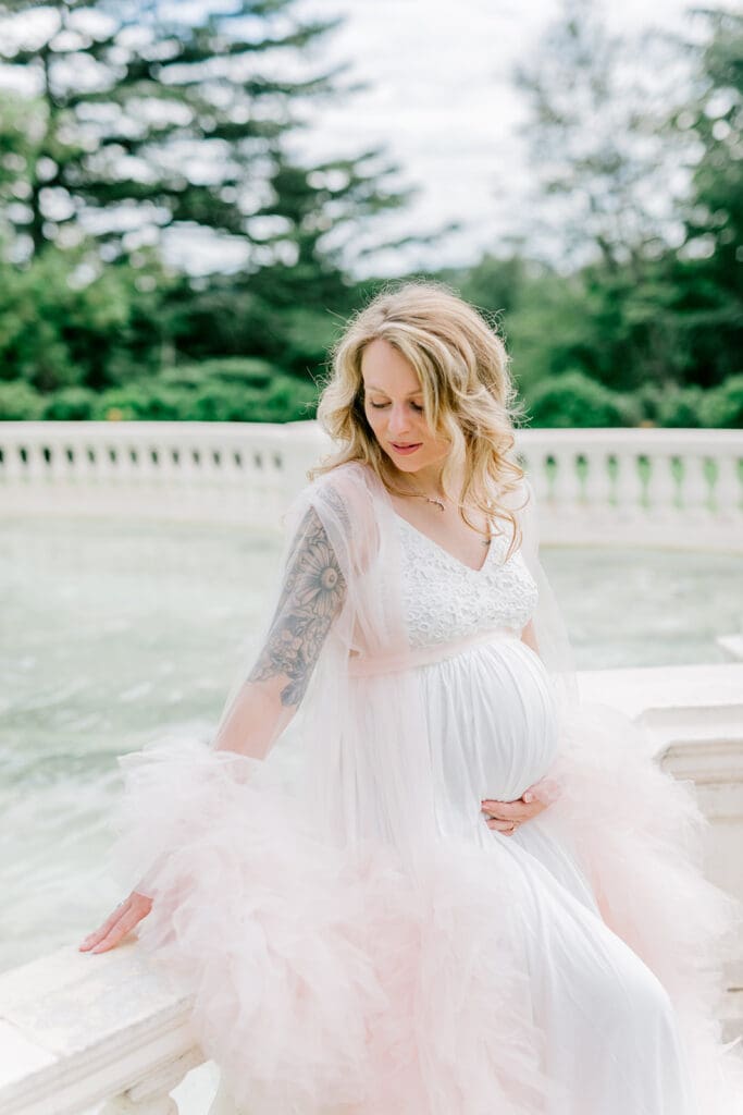 Maymont spring maternity photography featuring Cameron in a flowing pink gown surrounded by blooming gardens.