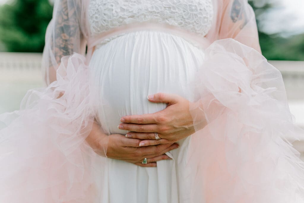 Maymont spring maternity photography featuring Cameron in a flowing pink gown surrounded by blooming gardens.