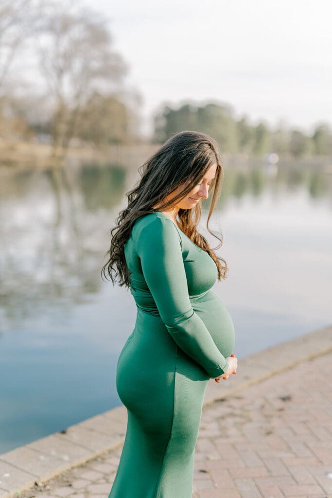 Byrd Park maternity session with Chelsea wearing a beautiful green dress that highlights her baby bump during golden hour.