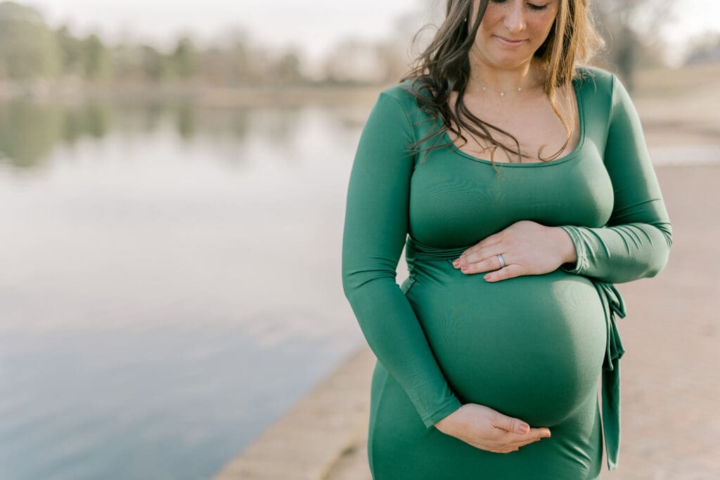 Byrd Park maternity session with Chelsea wearing a beautiful green dress that highlights her baby bump during golden hour.