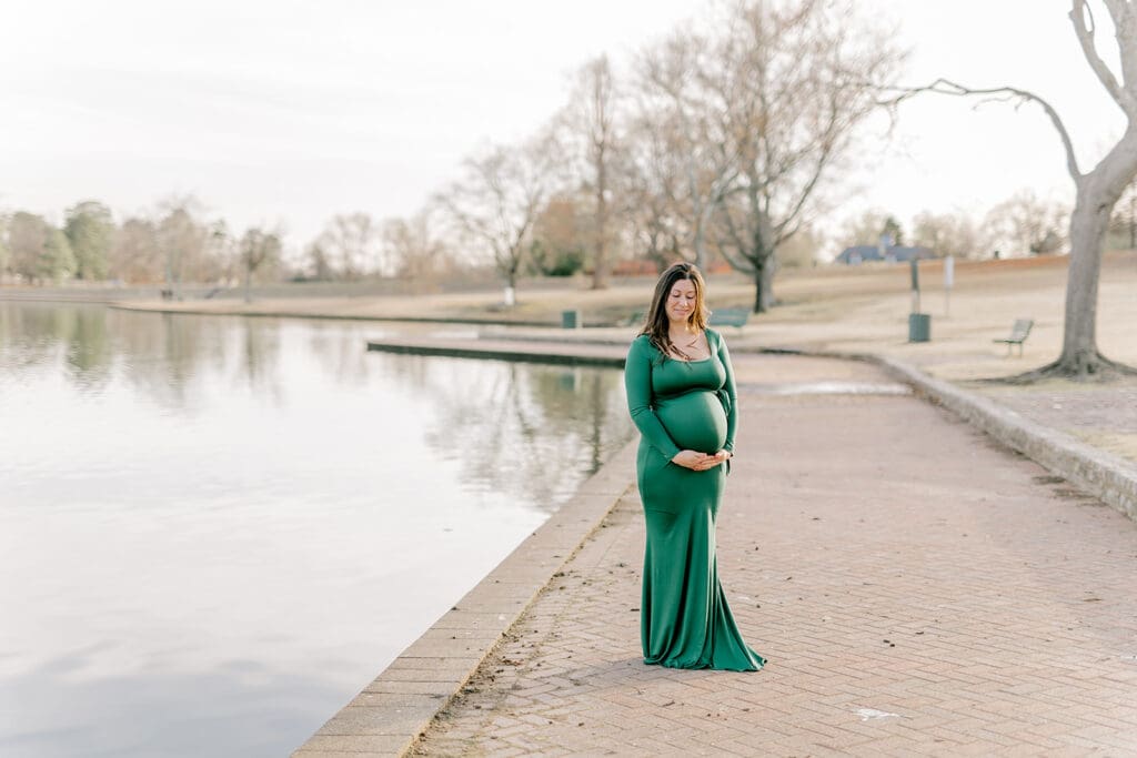 Byrd Park maternity session with Chelsea wearing a beautiful green dress that highlights her baby bump during golden hour.