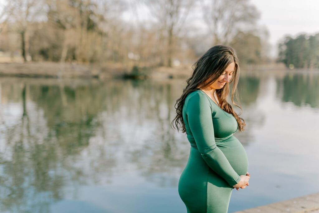 Byrd Park maternity session with Chelsea wearing a beautiful green dress that highlights her baby bump during golden hour.