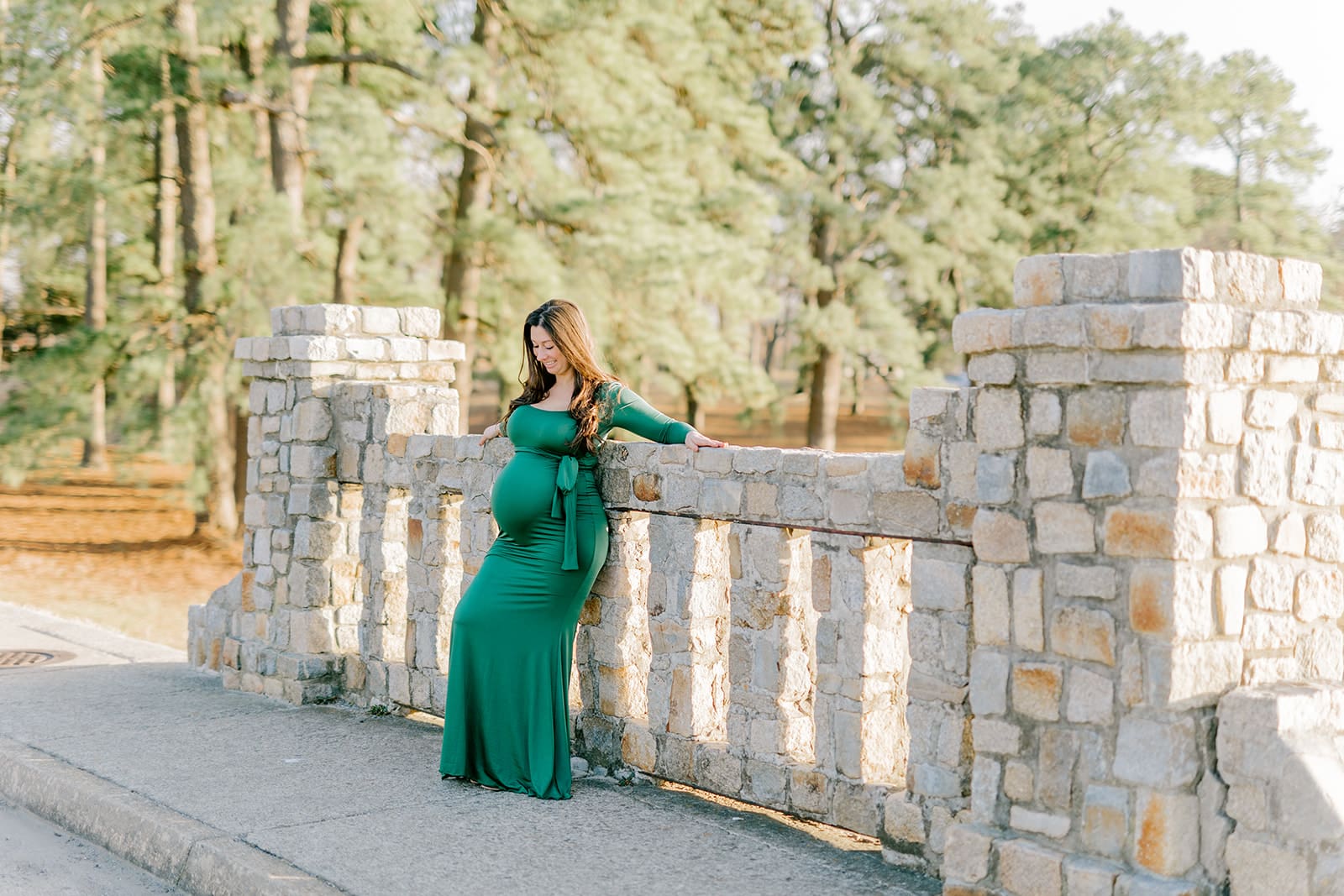 Byrd Park maternity session with Chelsea wearing a beautiful green dress that highlights her baby bump during golden hour.