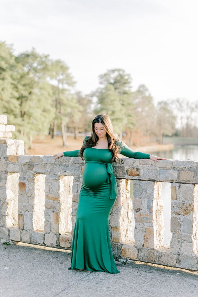 Byrd Park maternity session with Chelsea wearing a beautiful green dress that highlights her baby bump during golden hour.