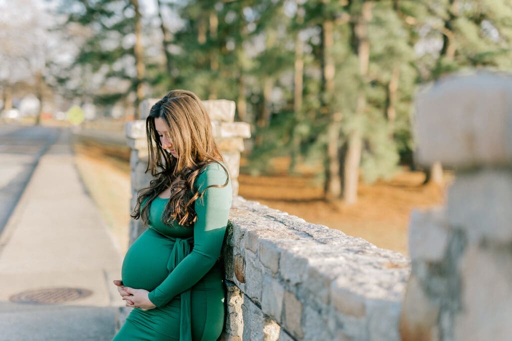 Byrd Park maternity session with Chelsea wearing a beautiful green dress that highlights her baby bump during golden hour.