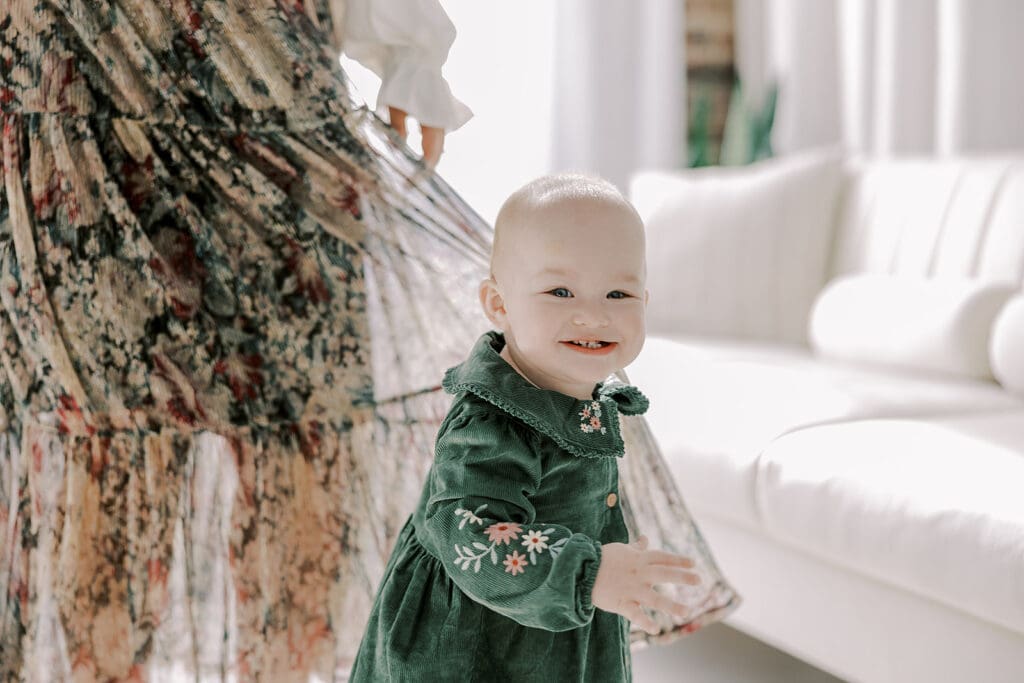 Richmond studio family session featuring the stylish Cooney family celebrating their daughter's first birthday with joyful expressions.