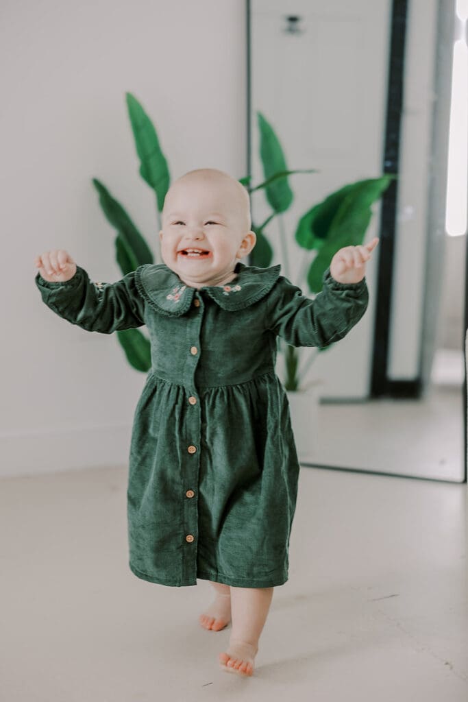 Richmond studio family session featuring the stylish Cooney family celebrating their daughter's first birthday with joyful expressions.