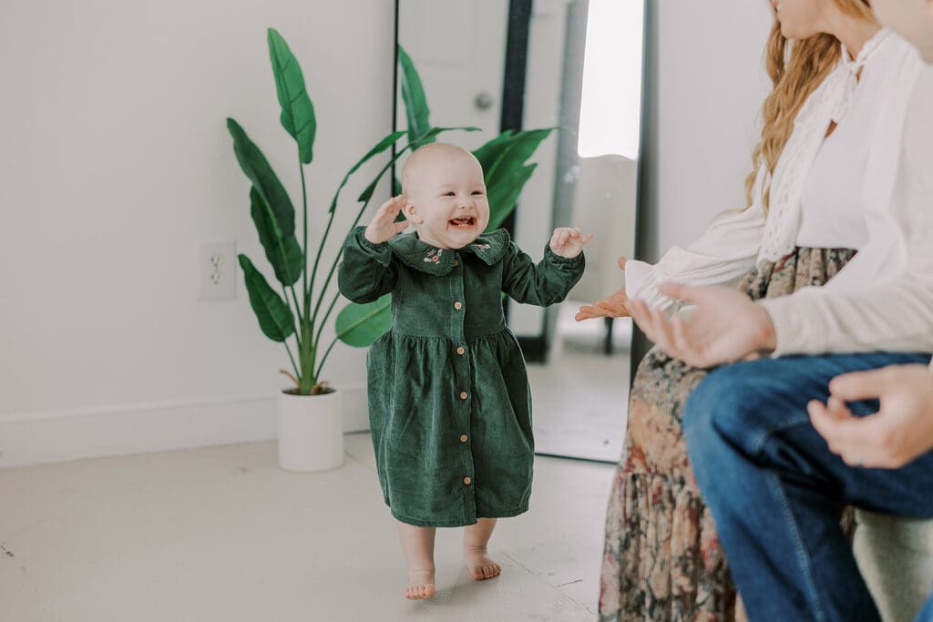 Richmond studio family session featuring the stylish Cooney family celebrating their daughter's first birthday with joyful expressions.