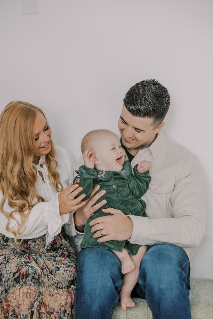 Richmond studio family session featuring the stylish Cooney family celebrating their daughter's first birthday with joyful expressions.