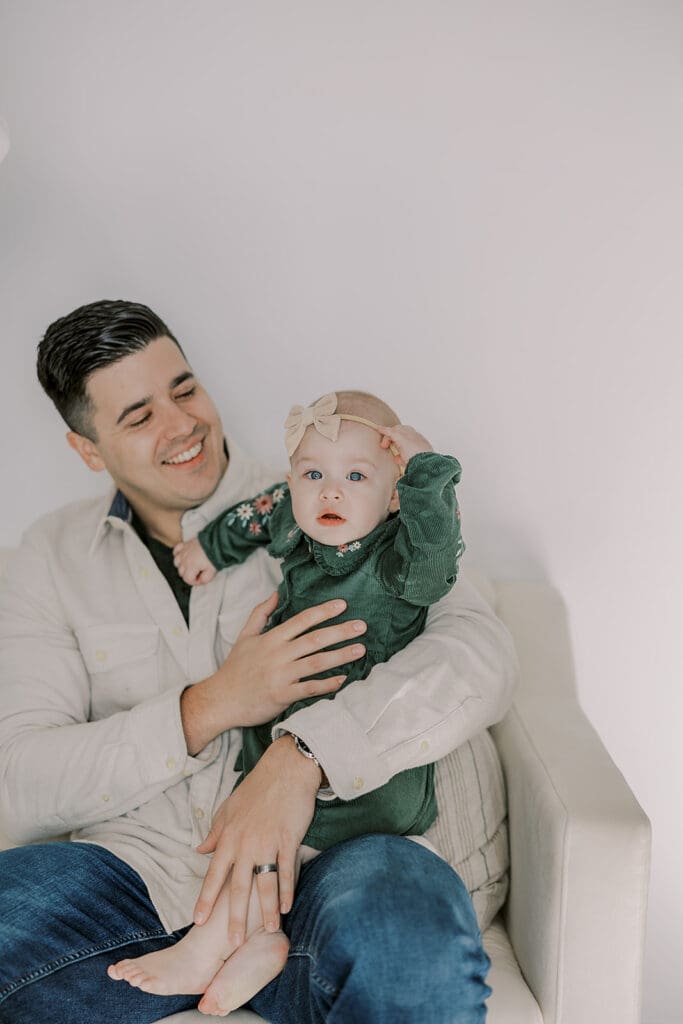 Richmond studio family session featuring the stylish Cooney family celebrating their daughter's first birthday with joyful expressions.