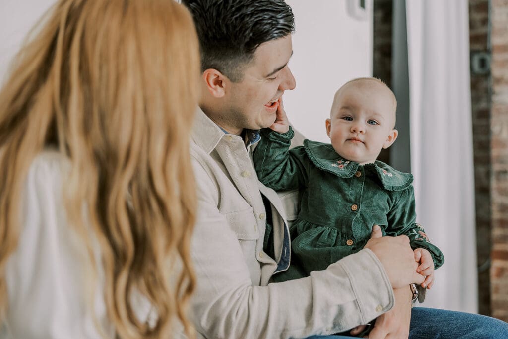 Richmond studio family session featuring the stylish Cooney family celebrating their daughter's first birthday with joyful expressions.