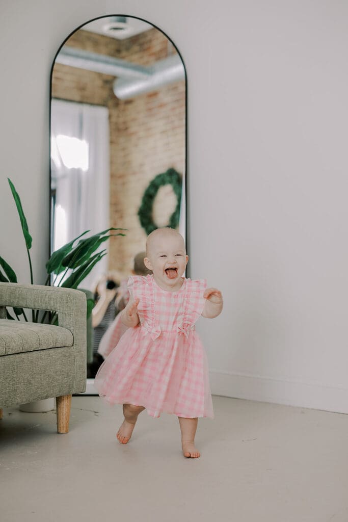 Richmond studio family session featuring the stylish Cooney family celebrating their daughter's first birthday with joyful expressions.