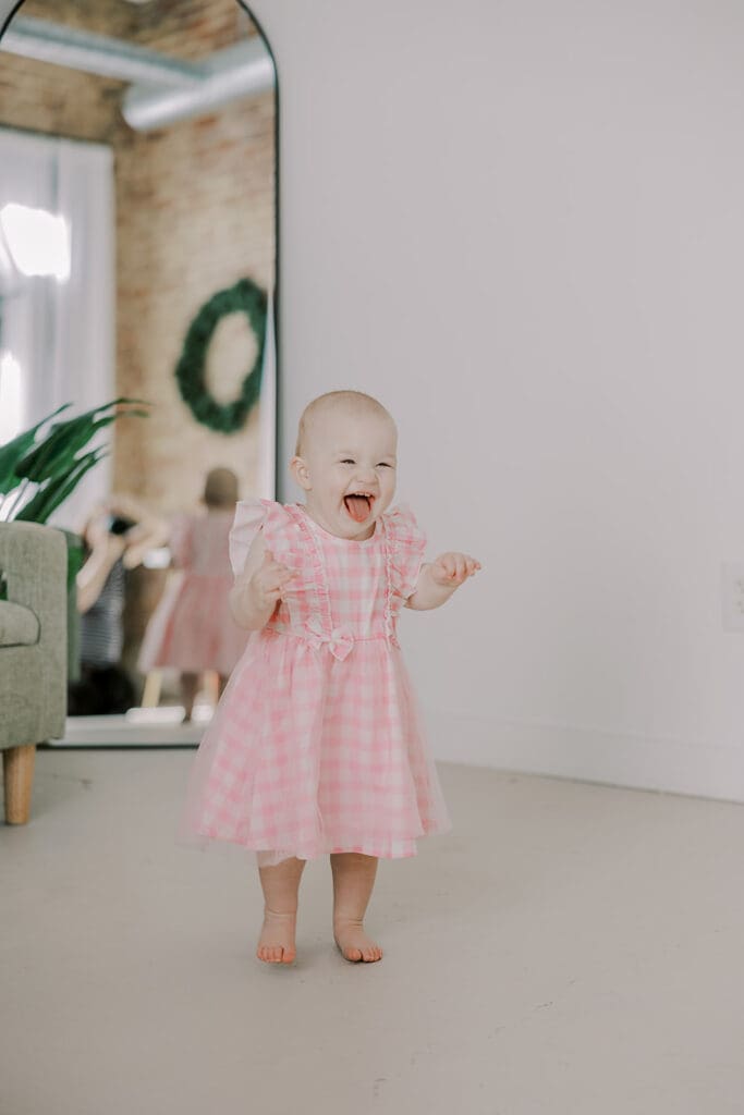 Richmond studio family session featuring the stylish Cooney family celebrating their daughter's first birthday with joyful expressions.