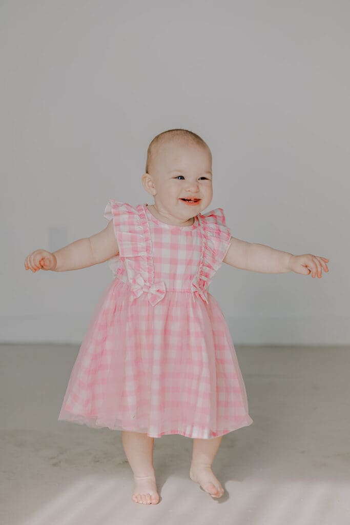 Richmond studio family session featuring the stylish Cooney family celebrating their daughter's first birthday with joyful expressions.