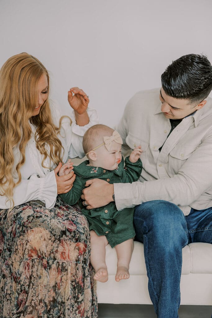 Richmond studio family session featuring the stylish Cooney family celebrating their daughter's first birthday with joyful expressions.