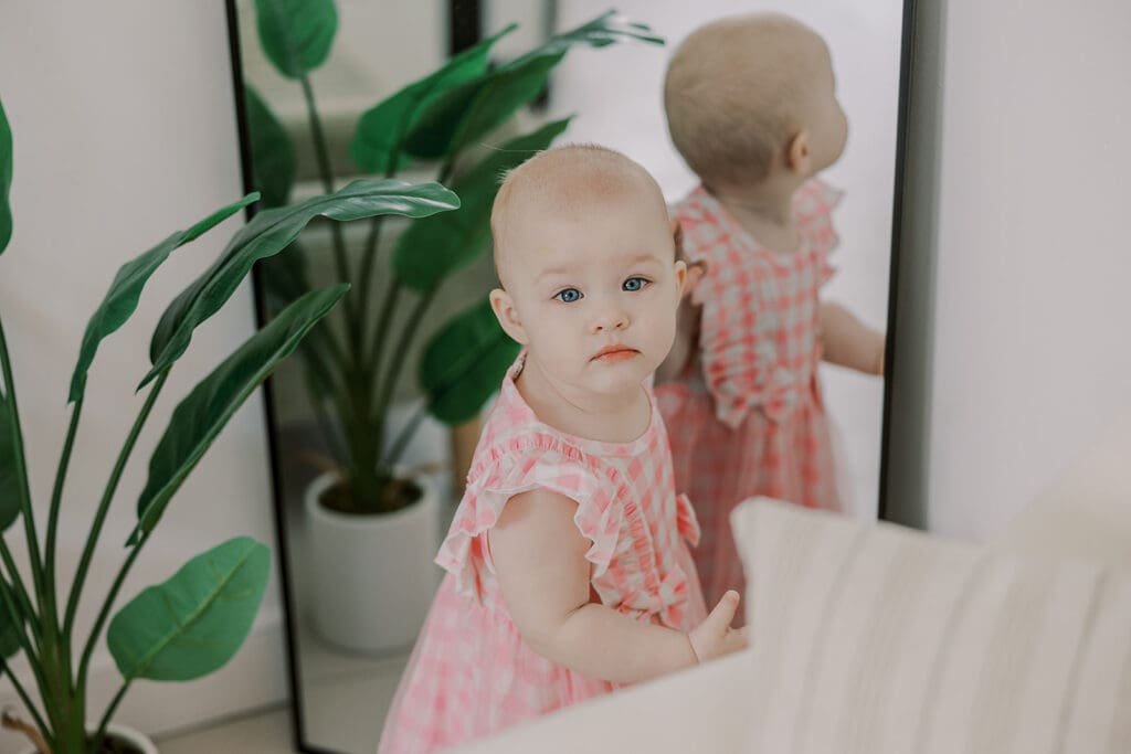 Richmond studio family session featuring the stylish Cooney family celebrating their daughter's first birthday with joyful expressions.