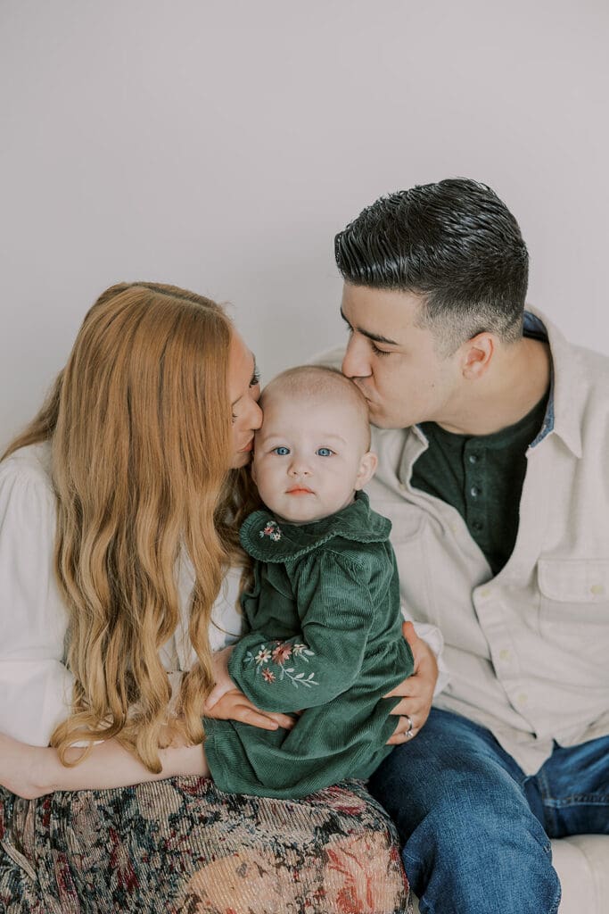 Richmond studio family session featuring the stylish Cooney family celebrating their daughter's first birthday with joyful expressions.