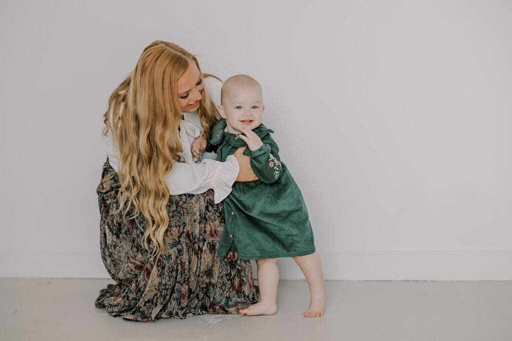 Richmond studio family session featuring the stylish Cooney family celebrating their daughter's first birthday with joyful expressions.