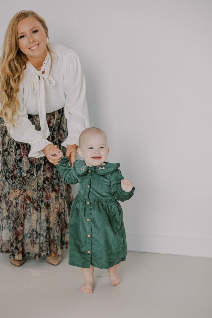 Richmond studio family session featuring the stylish Cooney family celebrating their daughter's first birthday with joyful expressions.