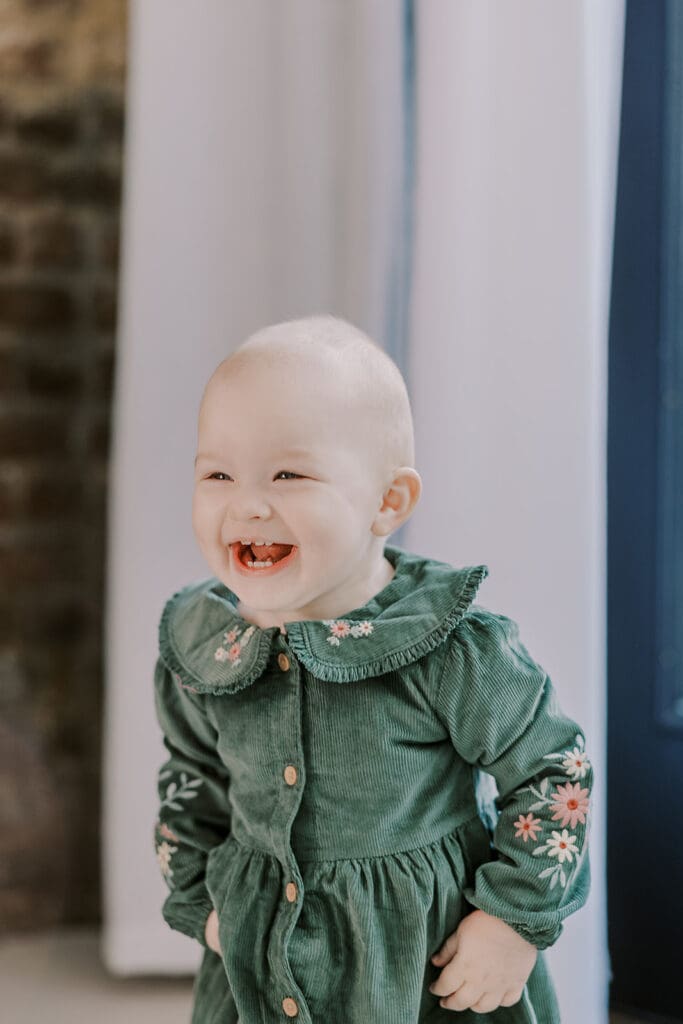 Richmond studio family session featuring the stylish Cooney family celebrating their daughter's first birthday with joyful expressions.