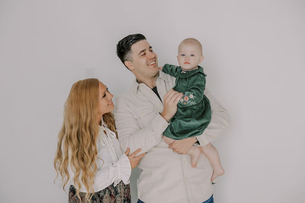 Richmond studio family session featuring the stylish Cooney family celebrating their daughter's first birthday with joyful expressions.