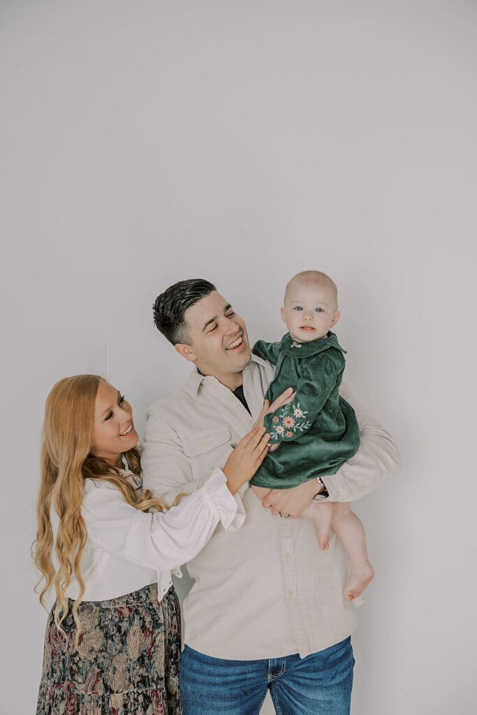 Richmond studio family session featuring the stylish Cooney family celebrating their daughter's first birthday with joyful expressions.