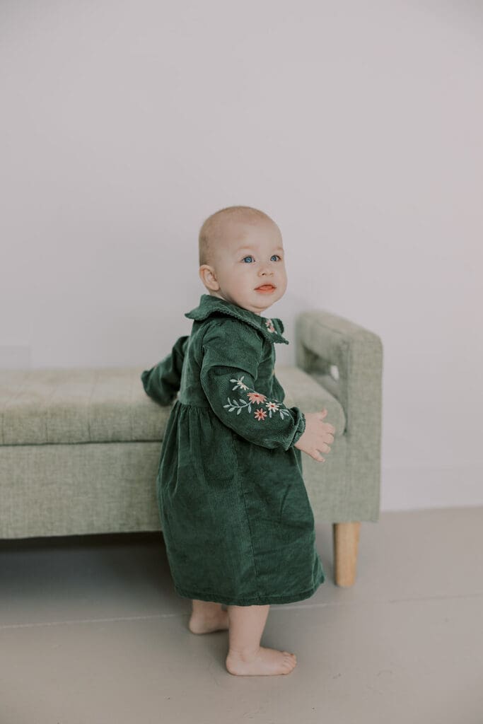 Richmond studio family session featuring the stylish Cooney family celebrating their daughter's first birthday with joyful expressions.