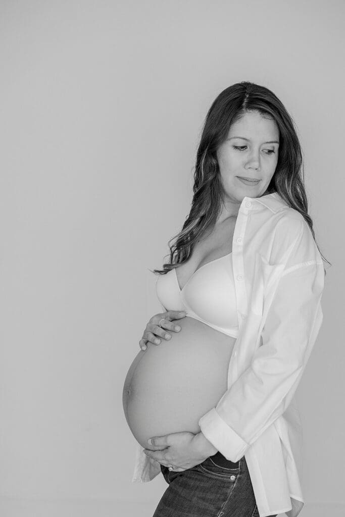 Studio maternity photography in Richmond showing the Holguins with flowers, ultrasound pictures and simple elegant backdrops.