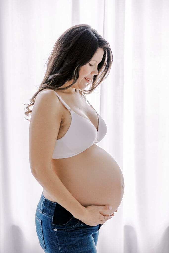 Studio maternity photography in Richmond showing the Holguins with flowers, ultrasound pictures and simple elegant backdrops.